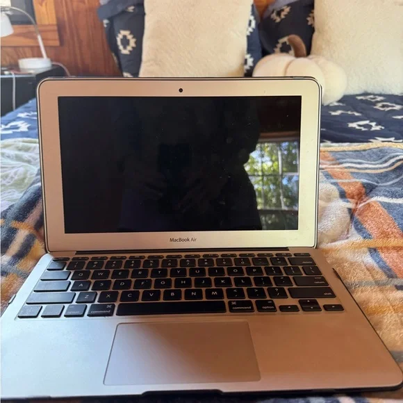 Apple Laptop with Black Cover and Decorative Stickers